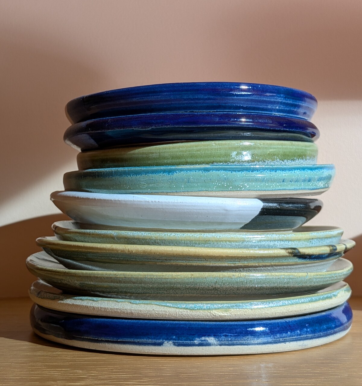 A stack of colorful glazed ceramic plates